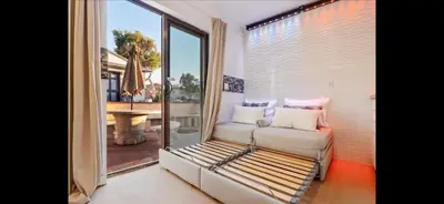 a living room with a couch and a large window at Mission Beach Suite Parking Steps 2 Ocean in San Diego