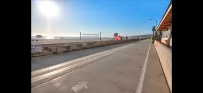 an empty road next to a beach with a goal at Mission Beach Suite Parking Steps 2 Ocean in San Diego