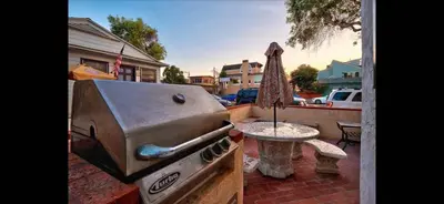a grill and a table on a patio at Mission Beach Suite Parking Steps 2 Ocean in San Diego