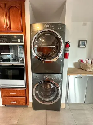 a washer and dryer in a kitchen next to a microwave at Mission Beach Loft Garage Steps 2 Ocean in San Diego