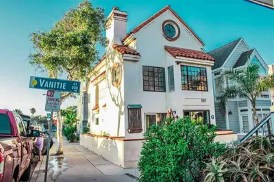 a white house with a street sign in front of it at Entire Mission Beach Duplex Steps 2 the Ocean & Bay 2 Parking Spots in San Diego