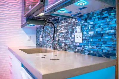 a kitchen with a sink and a tile wall at Entire Mission Beach Duplex Steps 2 the Ocean & Bay 2 Parking Spots in San Diego