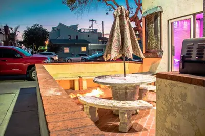 a table with an umbrella sitting on a patio at Entire Mission Beach Duplex Steps 2 the Ocean & Bay 2 Parking Spots in San Diego