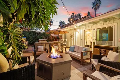 a patio with a fire pit in the middle at Stay & Play Pacific Beach Compound in San Diego