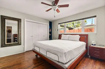a bedroom with a bed and a ceiling fan at Stay & Play Pacific Beach Compound in San Diego