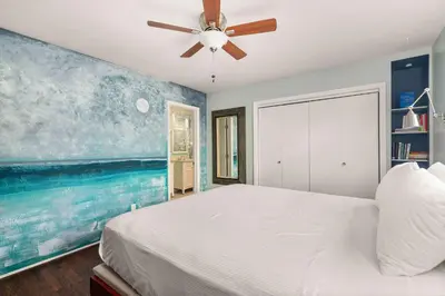 a bedroom with a bed and a ceiling fan at Stay & Play Pacific Beach Compound in San Diego