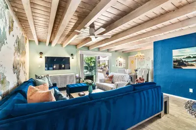 a living room with blue furniture and a blue wall at Stay & Play Pacific Beach Compound in San Diego