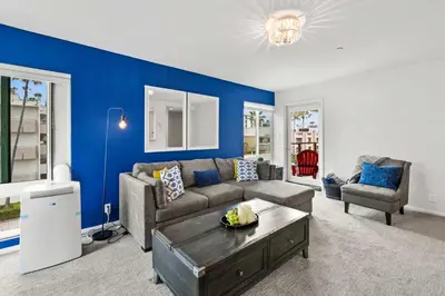 a living room with a couch and a table at Ocean front luxury condo with sunset views in San Diego
