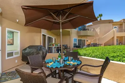 a table and chairs with an umbrella on a patio at 5N-53 Beach Bliss Ocean Views in Oceanside