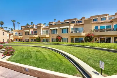a large apartment building with a lawn in front of it at 5N-53 Beach Bliss Ocean Views in Oceanside