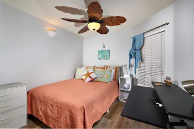 a bedroom with a bed and a ceiling fan at 501P-5 Panoramic Ocean & Pier Views in Oceanside