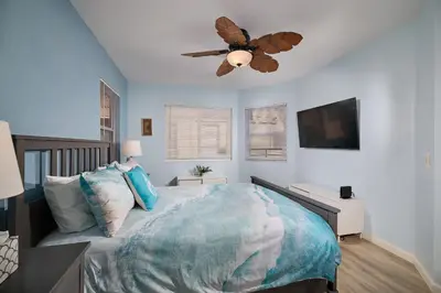 a bedroom with a bed and a ceiling fan at 501P-12 Spectacular Ocean Views Pet Friendly in Oceanside