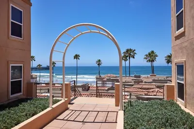 an archway leading to a beach with the ocean at 501P-12 Spectacular Ocean Views Pet Friendly in Oceanside