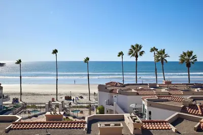 a view of a beach with palm trees and buildings at 501P-12 Spectacular Ocean Views Pet Friendly in Oceanside