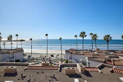 a view of the beach and a resort with palm trees at 501P-12 Spectacular Ocean Views Pet Friendly in Oceanside