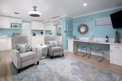 a blue kitchen with two chairs and a sink and a counter at Suite with Rooftop Deck and Ocean Views in Mission Bay in San Diego