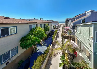 a city street with houses and palm trees at Ben's Beach Bungalow 1 150 Steps to Sand in San Diego