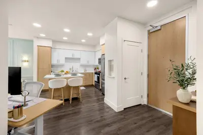 an open kitchen and living room with a table and chairs at Luxury 1BR Newport Beach Condo with Pool and Gym in Newport Beach