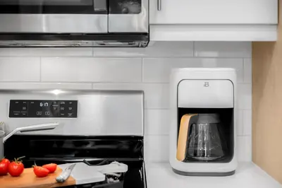 a kitchen with a coffee maker and a microwave at Luxury 1BR Newport Beach Condo with Pool and Gym in Newport Beach