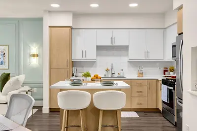 a kitchen with white cabinets and white counter tops at Luxury 1BR Newport Beach Condo with Pool and Gym in Newport Beach
