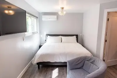 a bedroom with a bed and a chair at Charming Private Mission Bay Studio 1 in San Diego