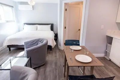 a bedroom with a bed and a table and chairs at Charming Private Mission Bay Studio 1 in San Diego