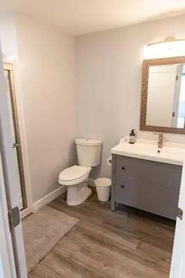 a bathroom with a toilet and a sink and a mirror at Charming Private Mission Bay Studio 1 in San Diego