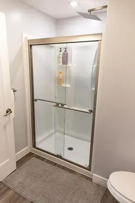 a glass shower in a bathroom with a toilet at Charming Private Mission Bay Studio 1 in San Diego