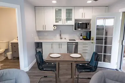 a kitchen with a table and chairs in a room at Charming Private Mission Bay Studio 1 in San Diego