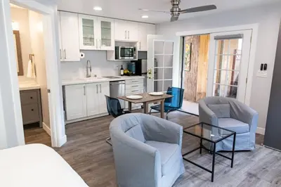 a living room with a table and chairs and a kitchen at Charming Private Mission Bay Studio 1 in San Diego