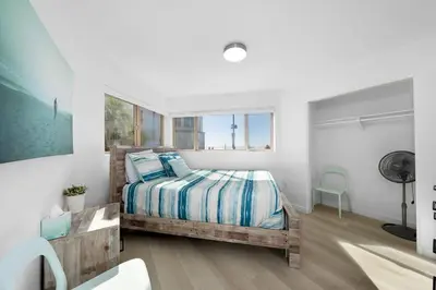 a bedroom with a bed with blue and white sheets at Family Ocean Front 3BR with Parking in San Diego