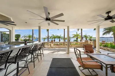 a patio with chairs and a bar with a view of the ocean at Family Luxurious Waterfront Escape in San Diego
