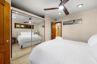 a bedroom with two beds and a mirror at Family Luxurious Waterfront Escape in San Diego
