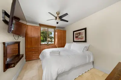 a bedroom with a bed and a ceiling fan at Family Luxurious Waterfront Escape in San Diego