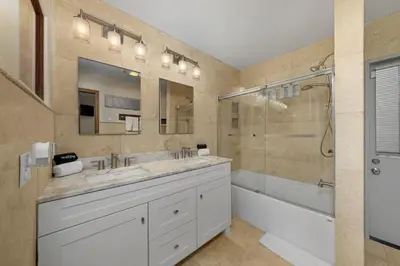 a bathroom with two sinks and a tub and a shower at Family Luxurious Waterfront Escape in San Diego
