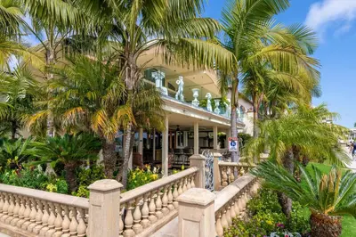 a house with palm trees in front of it at Family Luxurious Waterfront Escape in San Diego