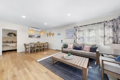 a living room with a couch and a table at Suite Cozy Beach Nook 150 Steps To The Sand in San Diego