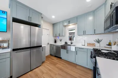 a kitchen with blue cabinets and stainless steel appliances at Suite Cozy Beach Nook 150 Steps To The Sand in San Diego