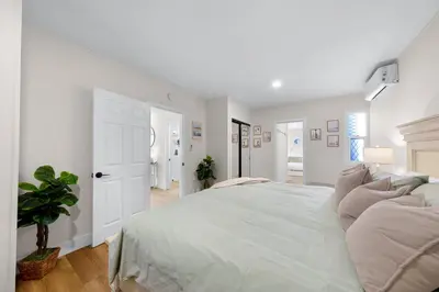 a white bedroom with a large bed with pillows at Suite Cozy Beach Nook 150 Steps To The Sand in San Diego