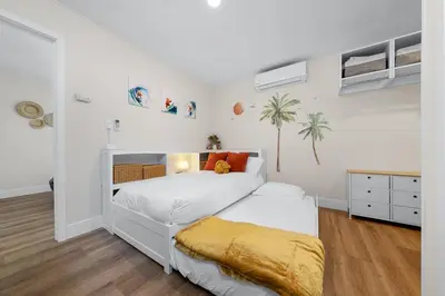 a white bedroom with a bed and a desk at Suite Cozy Beach Nook 150 Steps To The Sand in San Diego