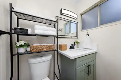 a bathroom with a toilet and a sink and a mirror at Suite Cozy Beach Nook 150 Steps To The Sand in San Diego
