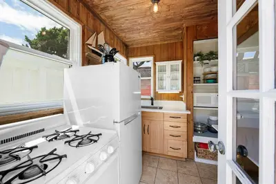 a kitchen with a stove and a white refrigerator at The Sweet Escape for 2 in San Diego