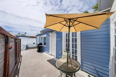 a patio with a table and an umbrella at The Sweet Escape for 2 in San Diego