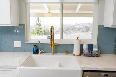 a white sink in a kitchen with a window at Family Hilltop luxe retreat with breathtaking views in La Mesa