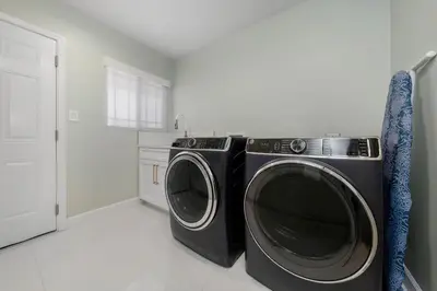 a laundry room with a washer and dryer at Family Hilltop luxe retreat with breathtaking views in La Mesa