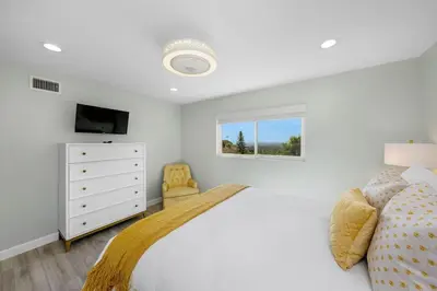 a white bedroom with a bed and a window at Family Hilltop luxe retreat with breathtaking views in La Mesa