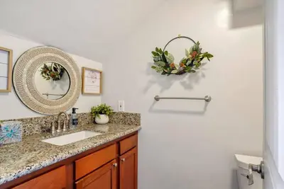 a bathroom with a sink and a mirror at Inviting 2-BR Condo in the heart of Imperial Beach in Imperial Beach
