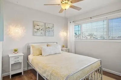 a bedroom with a bed and a ceiling fan at Inviting 2-BR Condo in the heart of Imperial Beach in Imperial Beach