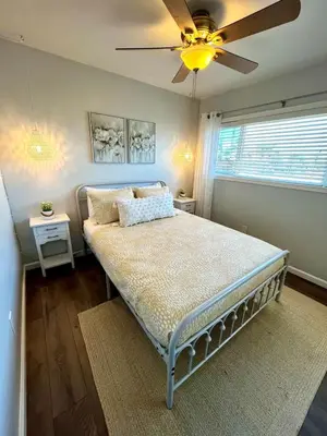 a bedroom with a bed with a ceiling fan at Inviting 2-BR Condo in the heart of Imperial Beach in Imperial Beach