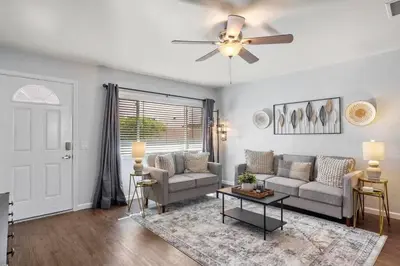 a living room with a couch and a ceiling fan at Inviting 2-BR Condo in the heart of Imperial Beach in Imperial Beach
